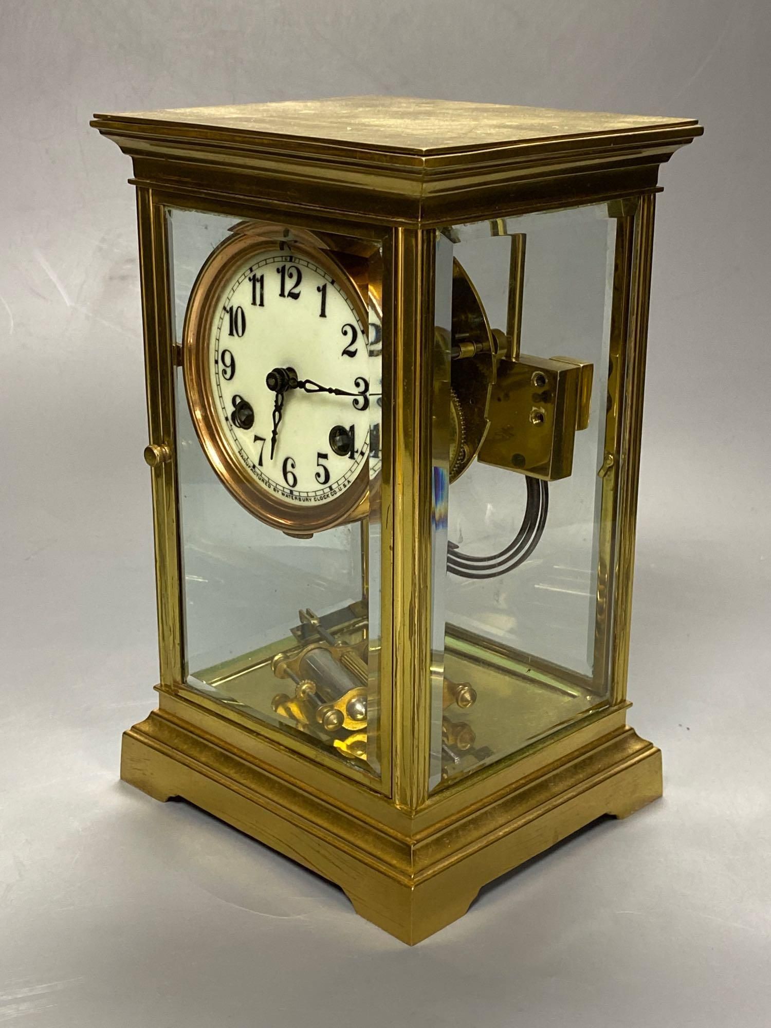 A lacquered brass four-glass mantel clock, Waterbury Clock Co., USA, gong striking movement, height 24cm